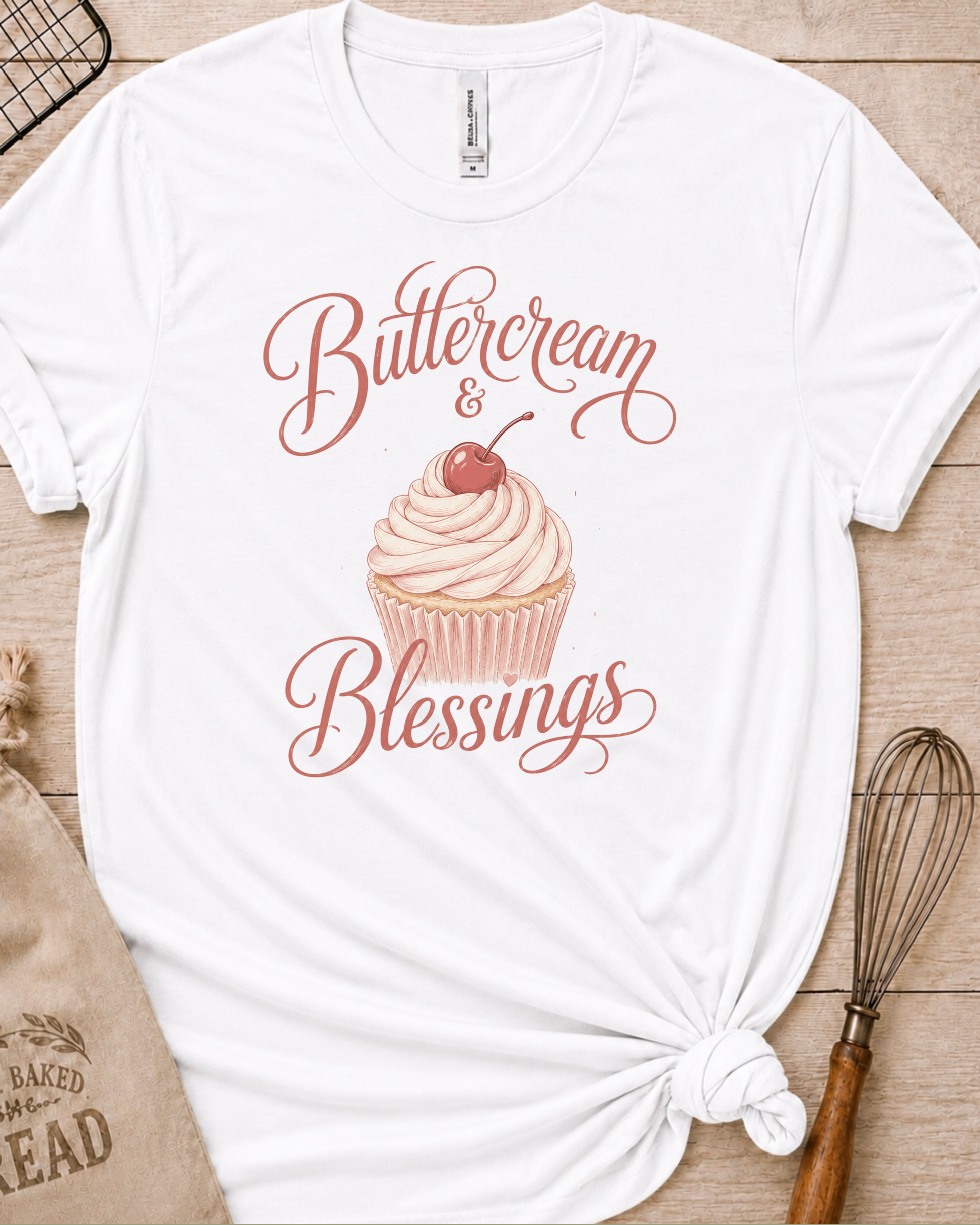 White women's relaxed fit t-shirt reading Buttercream and Blessings with a frosted cupcake illustration.