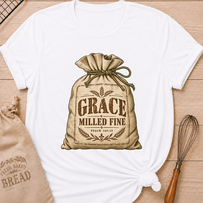 White women's relaxed fit tee with a vintage flour sack tied with rope, detailed with wheat motifs, Grace Milled Fine lettering and Psalm 145:15