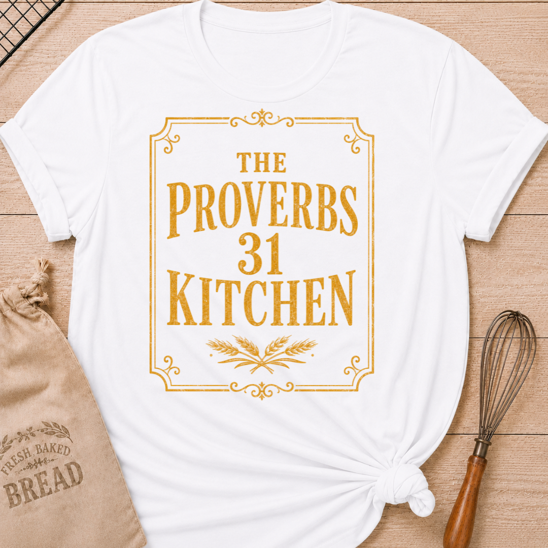 White women's relaxed fit t-shirt with the words The Proverbs 31 Kitchen in bold vintage lettering with wheat details in an old-fashioned bakery sign style.