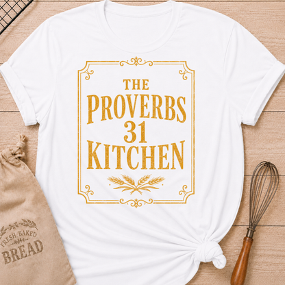 White women's relaxed fit t-shirt with the words The Proverbs 31 Kitchen in bold vintage lettering with wheat details in an old-fashioned bakery sign style.