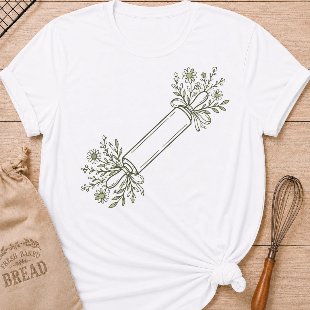 White women's relaxed fit t-shirt with a rolling pin dressed in soft floral sprigs and bows.